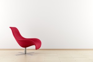 red armchair in front of white wall